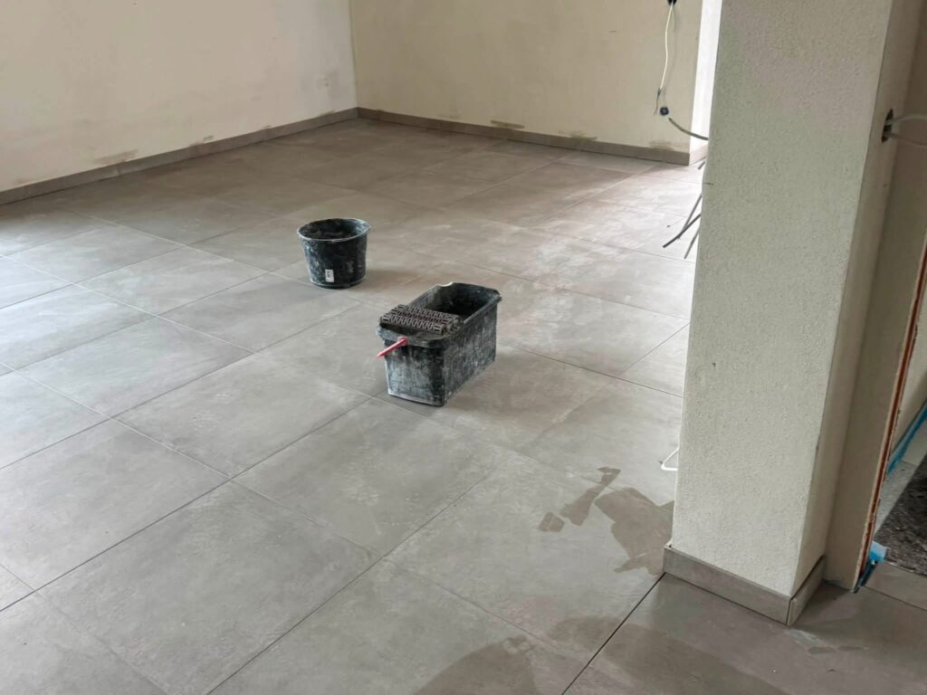 Großformatige Bodenfliesen in einem hellen Raum nach der Verlegung